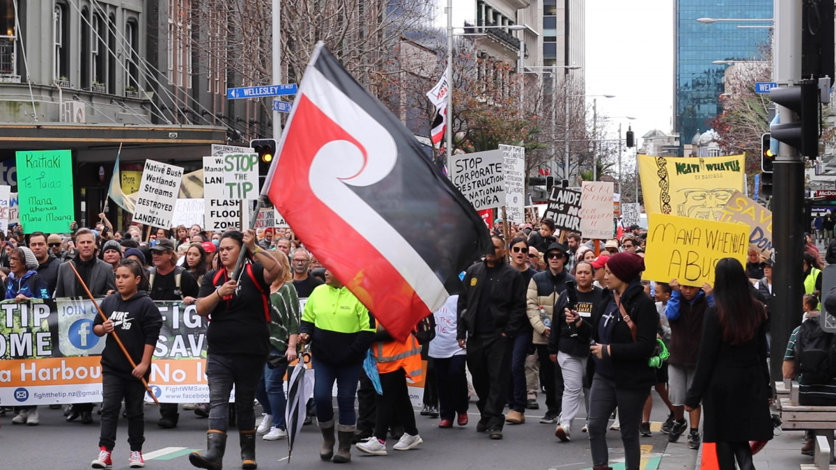 Hundreds march down Queen Street protesting the landfill