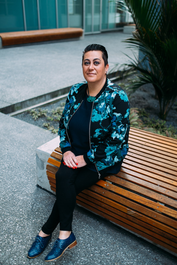 Khylee Quince sitting on a concrete bench