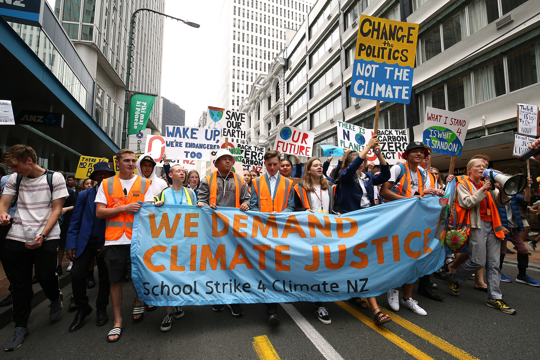 Students demonstrating with banners and signs for climate justice