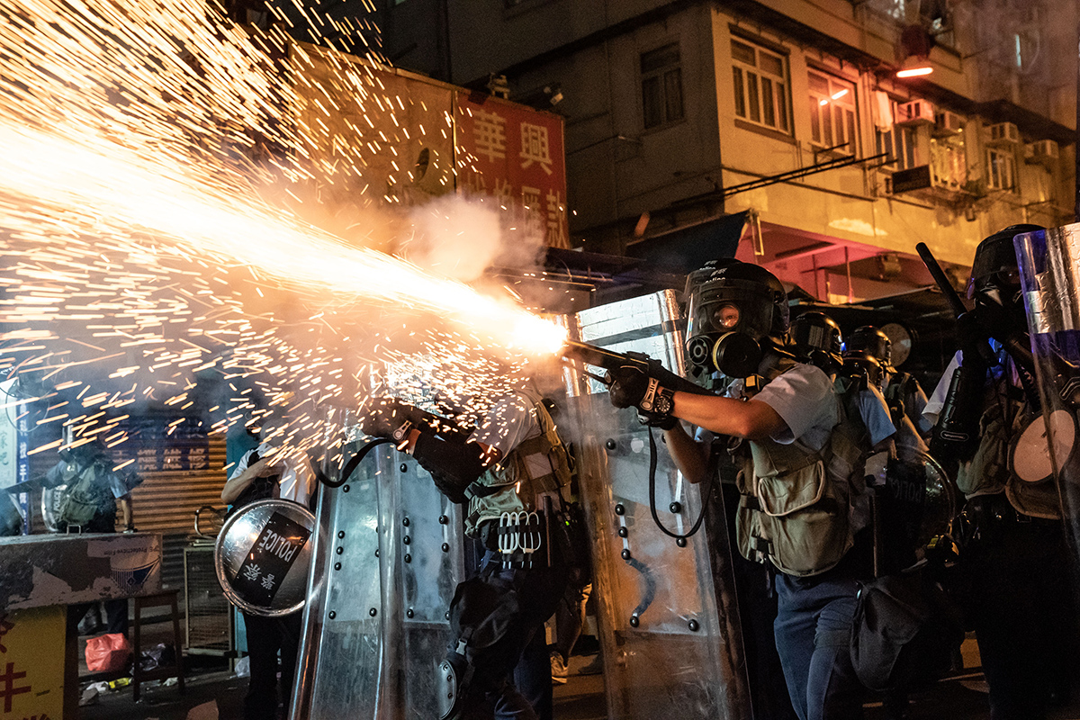 Riot police firing tear gas