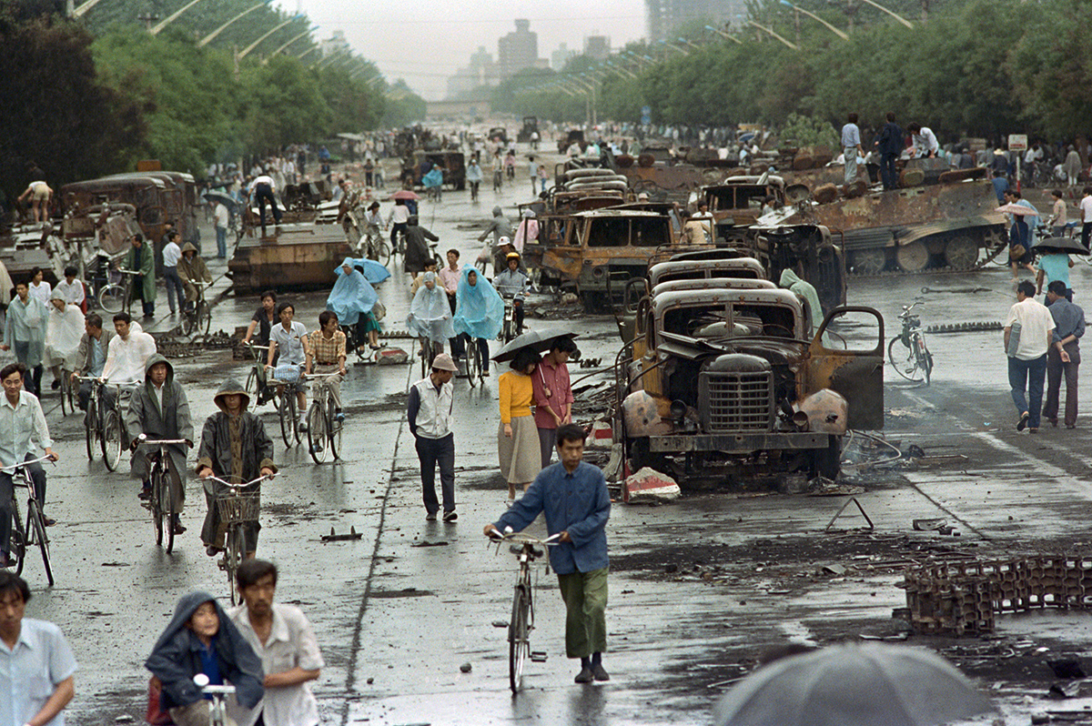 Walking Through Tiananmen Square Aftermath Photo by David Turnley Corbis VCG via Getty Images People biking and walking among destroyed vehicles and rubble