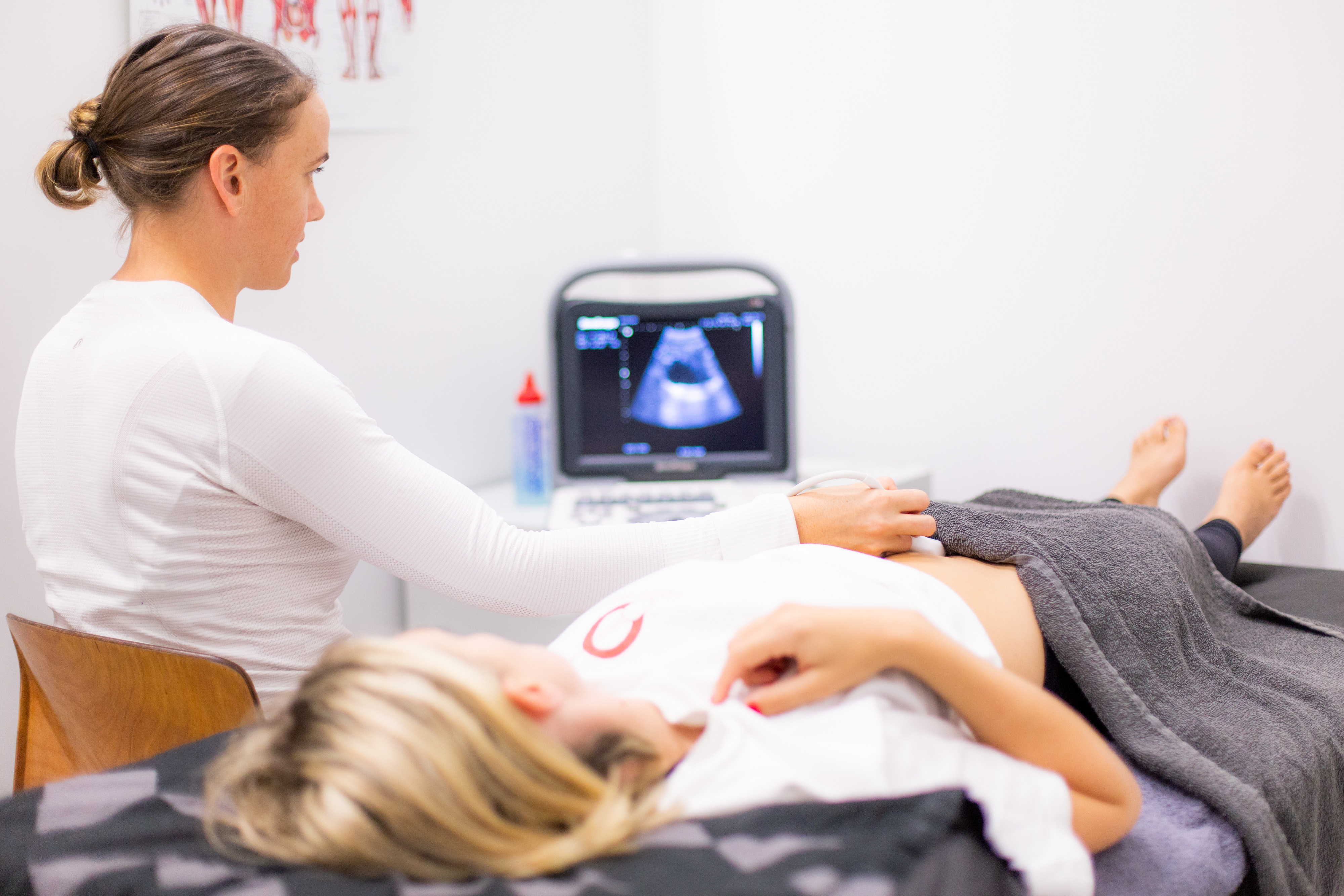 Caitlin giving woman an ultrasound scan